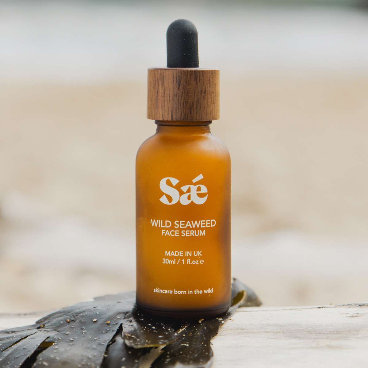 Hydrating face serum with seaweed extract in glass bottle